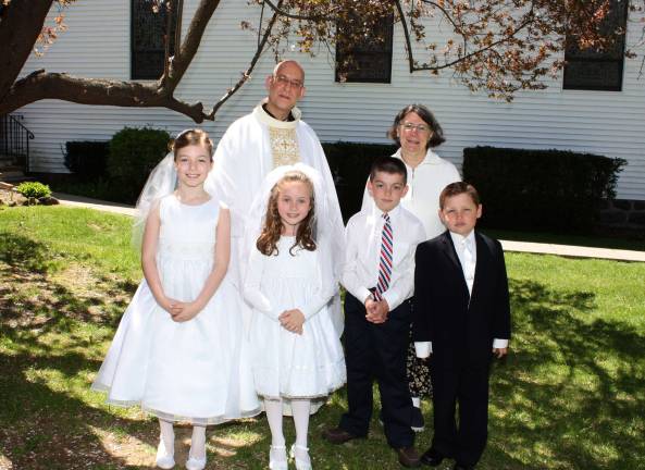 First Communicants at St. Joseph Church on Sunday, May 5, 2013. Pictured here are four of the 50 children who received the Sacrament this spring. From left, Emma Shorter, Cassidy Clinton, Albert Barbieri and Edward Satkowski. In rear is Rev. Steven Shadwell, administrator of St. Joseph Church, and Sr. Geraldine Corio, PBVM, director of Faith Formation.