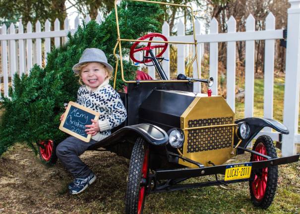 Submitted by Keith Rico of Warwick, N.Y. "My 2-year-old son Lucas posing with his Tin Lizzy (1950's era motorized scale model T) and his Christmas Tree!"