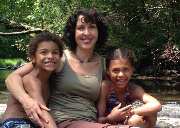 Tara Lambert with her twins. As a Native American, she is trying to pass on to her kids an older, more complex understanding of plant helpers than what they are learning at school.