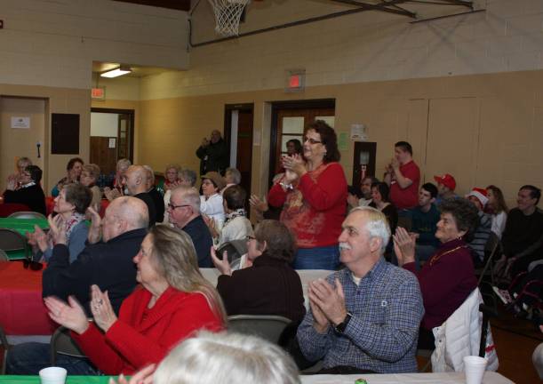 Photos by Ginny Raue Members of the audience show their appreciation of the talented high schoolers who shared their beautiful voices with them for a morning of holiday cheer.