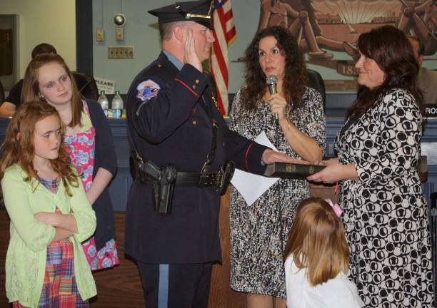 Newly minted Sergeant Joseph Nevin was surrounded by his wife and three daughters as he took his oath as a sergeant in the West Milford Police Department. Mayor Bettina Bieri administered the oath.