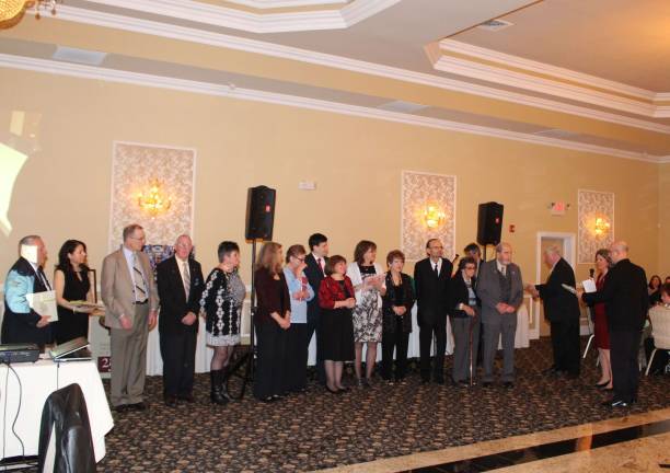 It takes a village. Members of the 250th Jubilee committee received a hearty round of applause for their work during the planning and execution of the many celebratory events throughout the year. They were presented with plaques crafted from the doors of the 1905 church, the current structure and home to many Catholics in the area.