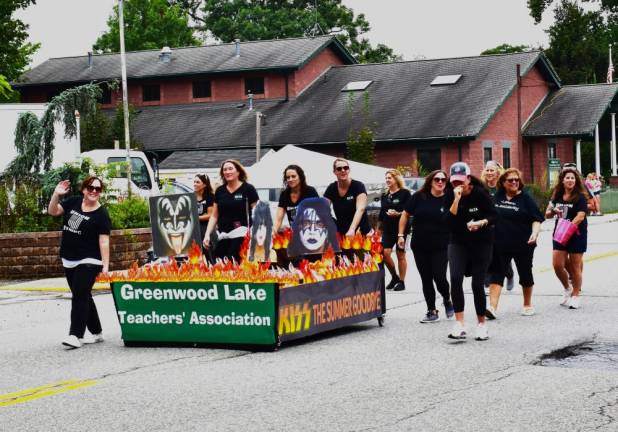 Members of the Greenwood Lake Teachers’ Association push their bed in the parade.