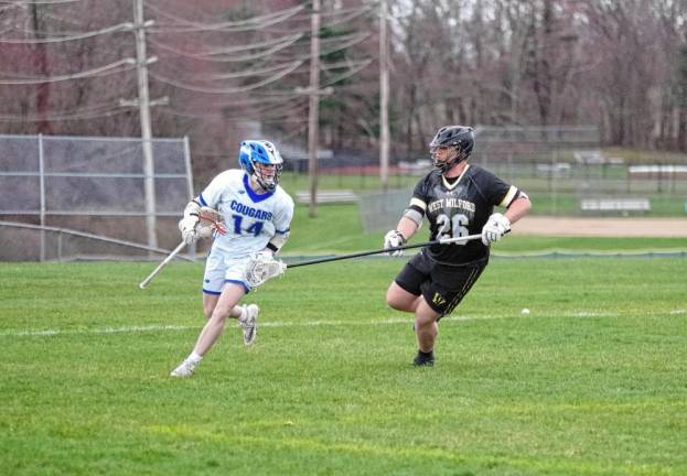 Kittatinny’s Carter Festa carries the ball while being shadowed by West Milford’s Spencer Ribitzki. Festa is credited with scooping up three ground balls.