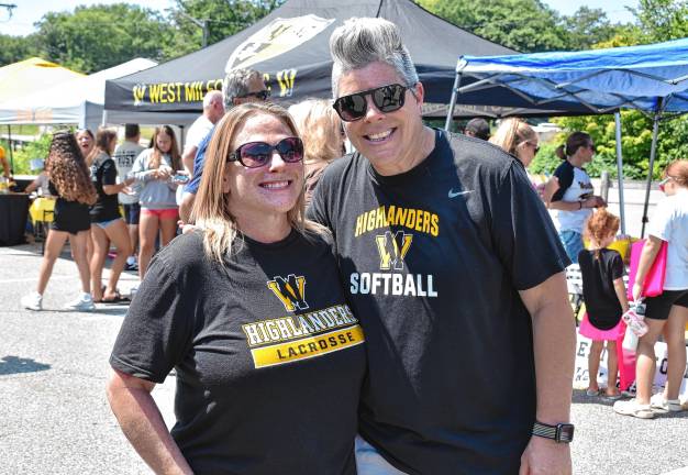 Softball coach Nicole Gwinnett, right, with pitcher Robyn Baron Brix, who graduated in 1991.
