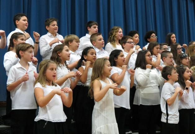 The fifth and sixth grade chorus sang and acted out their songs.