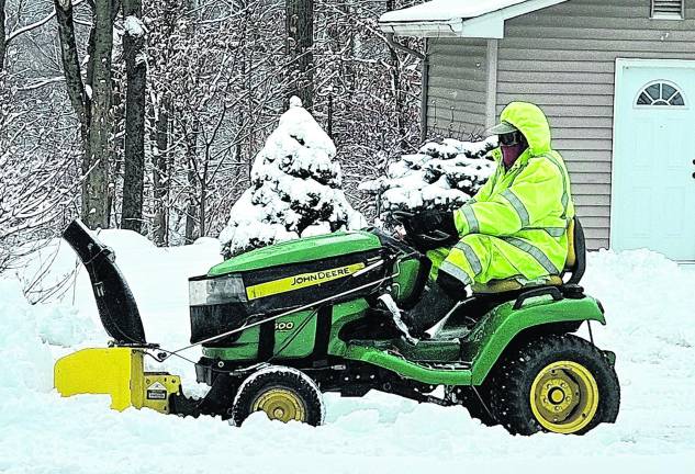 An area man plows his driveway after about 5 inches of swow fell on West Milford on Friday and Saturday.