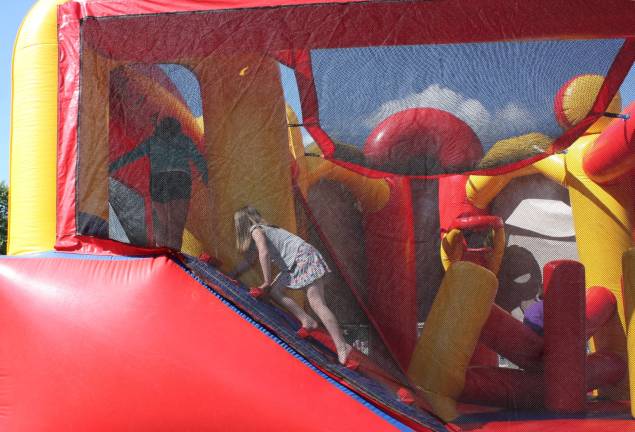 Giant bounce houses provided climbing and bouncing for the kids. Photo by Ginny Raue
