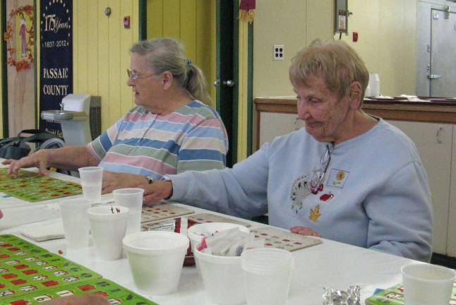 Photos by Ginny Privitar Pat Burd and Avonne Casella are intent on their bingo at Camp Hope Tuesday. They attend the Tuesday Supper Club.