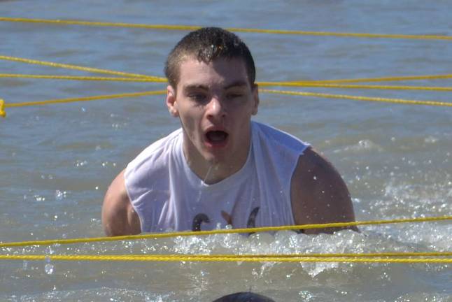 Matt Majewski comes through the water obstacle at the Battle of Beach in Wildwood, all to benefit the Special Olympics.