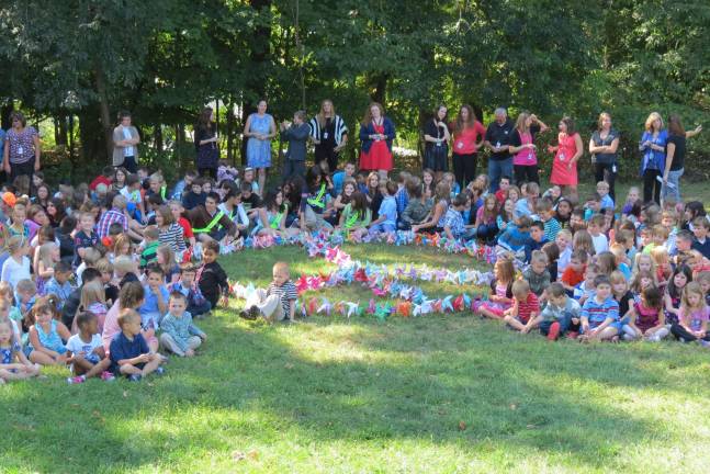 Students and teachers from Apshawa Elementary School planted their pinwheels in a peace sign.