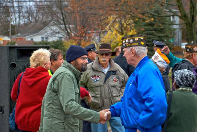 Photos by Don Webb Bob Kochka, left, shakes hands with a local veteran after Wednesday's Veterans Day ceremony at Memorial Park.