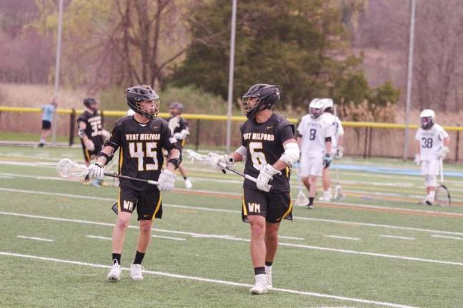 West Milford teammates Aidan Bolger (45) and Sam Petronaci (6) converse during a break in the action on the field.