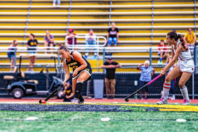 Cara Bruce moves the ball up the field.