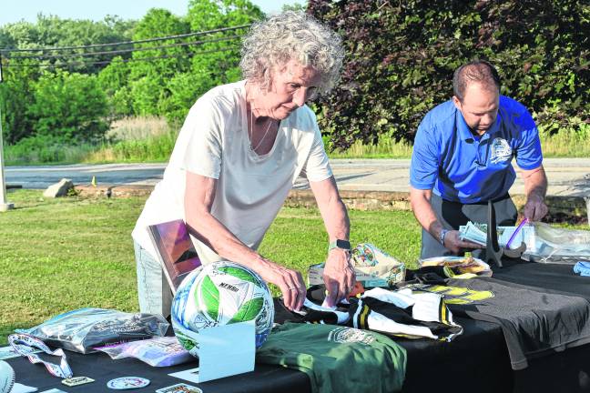 Items are prepared for insertion into the time capsule by Wallisch Homestead Treasurer Susan Lynch, left, and West Milford Community Services and Recreation Department Director Daniel Kochakji