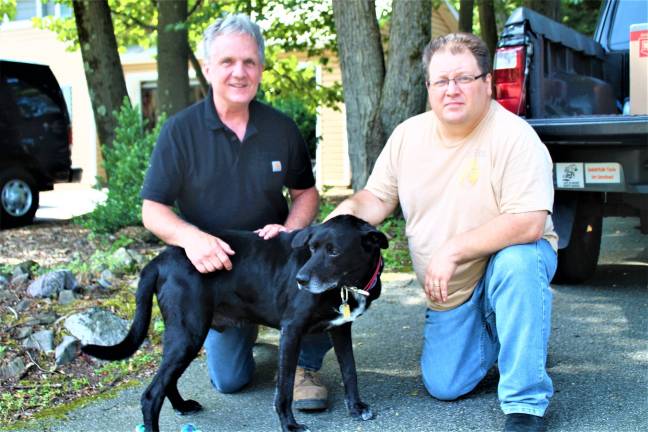 Dog owner Alan Tlusty and neighbor Mark Stinziano with the hero, Riley. garrett hemmerich photos