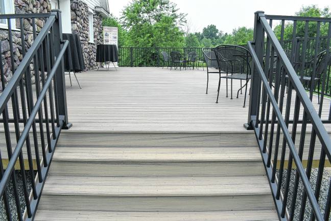 The new 20’ x 40’ beige Trex deck adorns the back of the Wallisch Homestead historic barn.