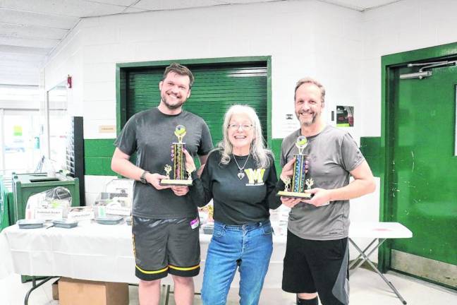 Debbie O’Brien, coordinator of the Municipal Alliance, presents trophies to Thomas and Ryan McNally, who won first place in the intermediate bracket. (Photo provided)