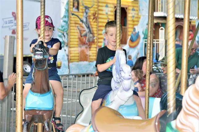 Kids ride the carousel a the annual Our Lady Queen of Peace carnival.