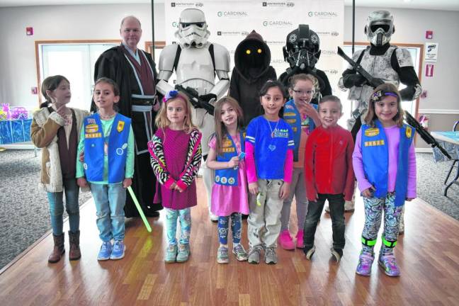 Children pose with Star Wars characters at the event.