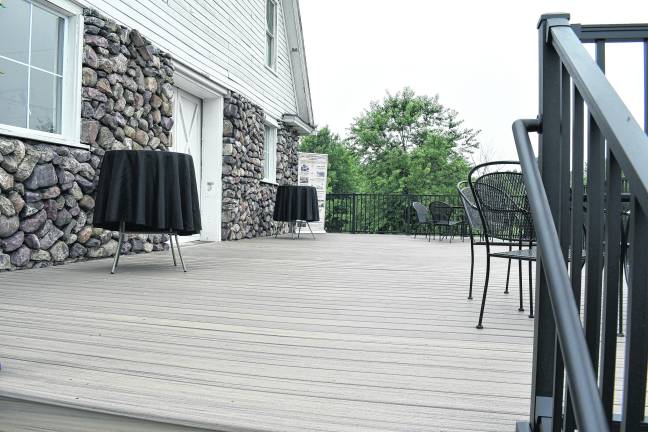 The new 20’ x 40’ beige Trex deck adorns the back of the Wallisch Homestead historic barn.