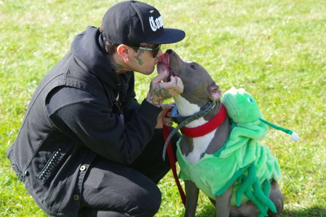 In the Give Me a Smooch contest, Raphael Desousa of White Plains, N.Y., got a wet kiss from Lui, a young male Blue Nose Pit Bull. The dog was dressed as a caterpillar. Desousa was in town visiting friends in West Milford.