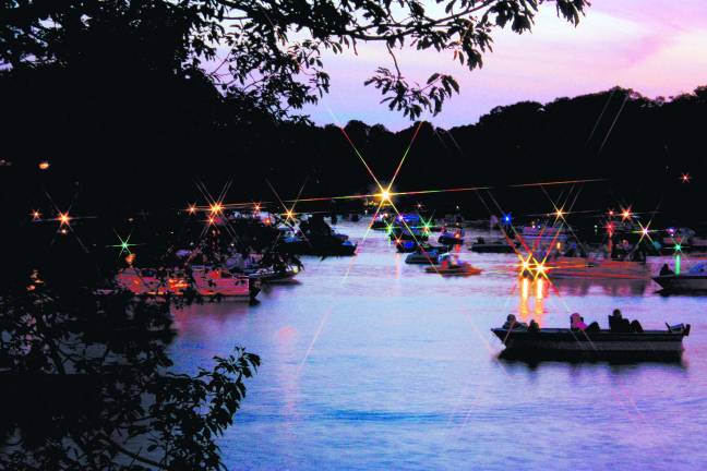 Darkness falls and the boaters on Upper Greenwood Lake are ready for the big fireworks show.