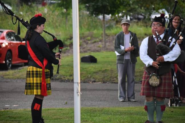 Joseph Smolinski and Ava Murphy play bagpipes during the ceremony.