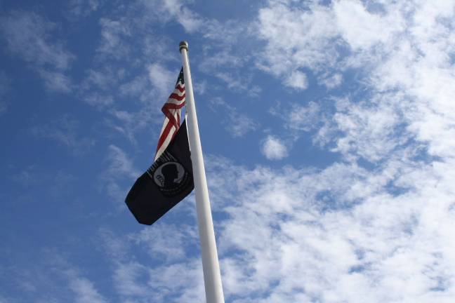 The flags against a beautiful blue sky.