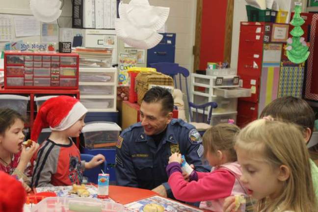Sergeant George Richnavsky spends some quality time with the kindergartners at Apshawa.