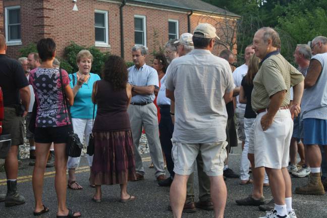 Homeowners and business owners talk outside of town hall before Wednesday night's meeting about how the revaluation is hurting them.