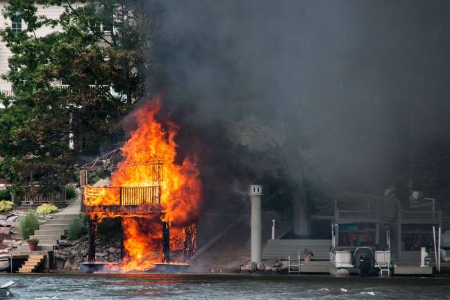 Photos courtesy of Don Wright A fire at a private boat house Monday destroyed the structure, a jet ski, rafts and kayaks.