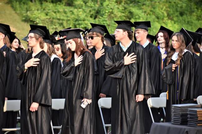 The graduates recite the Pledge of Allegiance.