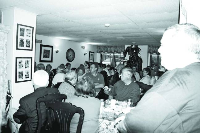 Photo by Linda Smith Hancharick About 70 people crammed into the Passport Cafe last Thursday night to hear about plans for the new library.