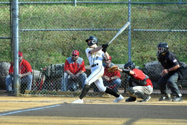 Senior catcher Charlie King hits the ball.