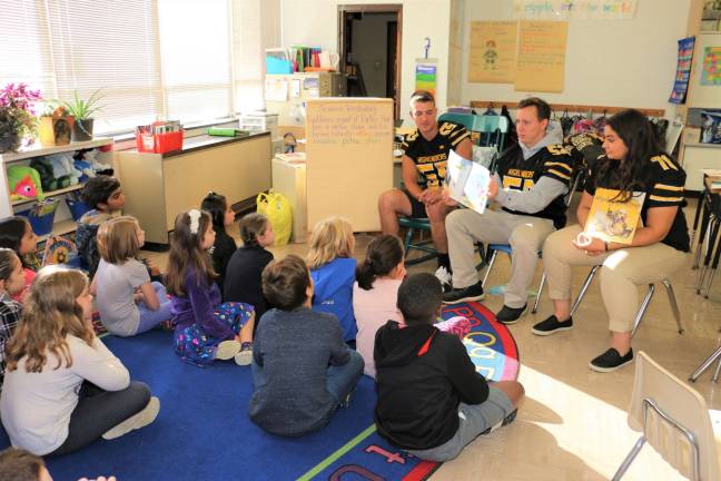 Highlanders AJ Bakunas (55), Dylan Purdy (52) and Angelina Bonsignore (76) read to third-graders at the Upper Greenwood Lake Elementary School. Photo by don Webb