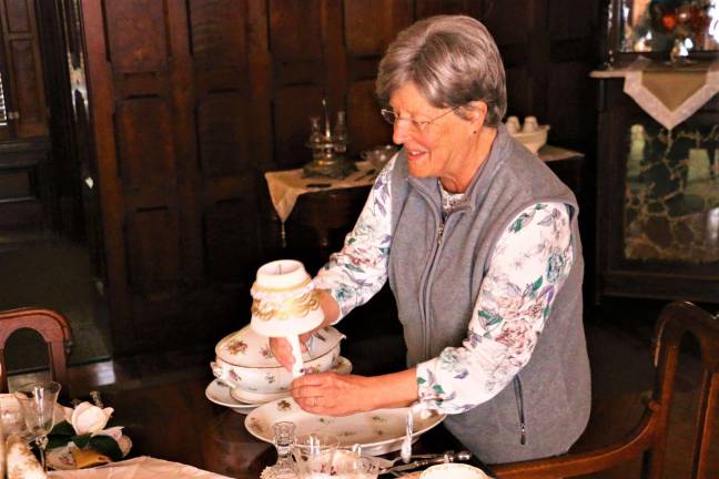 Carol Henkel sets the Christmas Dinner table at Ringwood Manor.