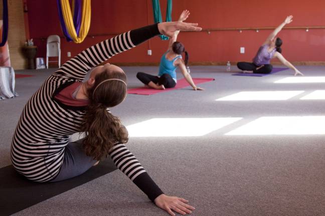 Photos by Glynnis Jones Instructor Sara Van Goor teaches a yoga class at the Andrea Powers Studio as part of a fund raiser last month.