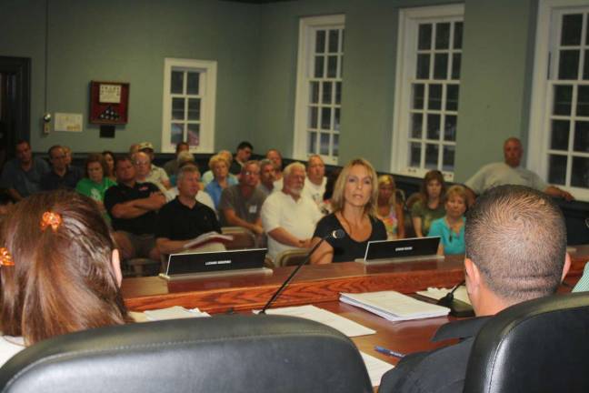 Maryann Minicus, owner of a new business on Route 23 The Tuscany Brew House, addresses the council Wednesday night as a representative of the business owners in town who have been hit hard by an increase in taxes.