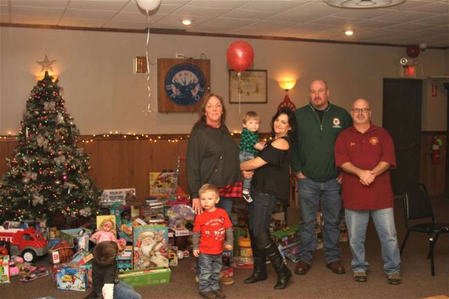 Charles Kim photo West Milford Elks Kim Powell, Linda Dolan, Kevin Goodsir and John Addice stand in front of the Christmas tree filled with donated toys at the lodge on Union Valley Road on Saturday.