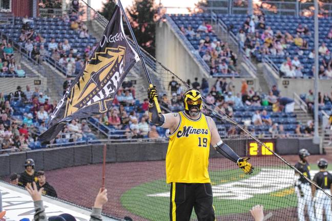 <b>Miner Man carries the team flag.</b>
