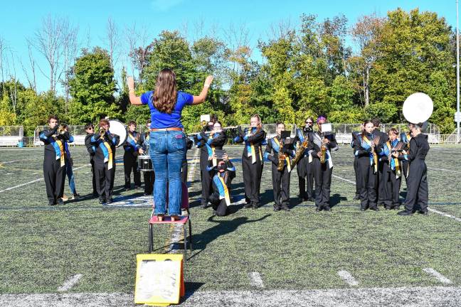 The Golden Falcons practice on the field before the competition, which included 11 high school bands.