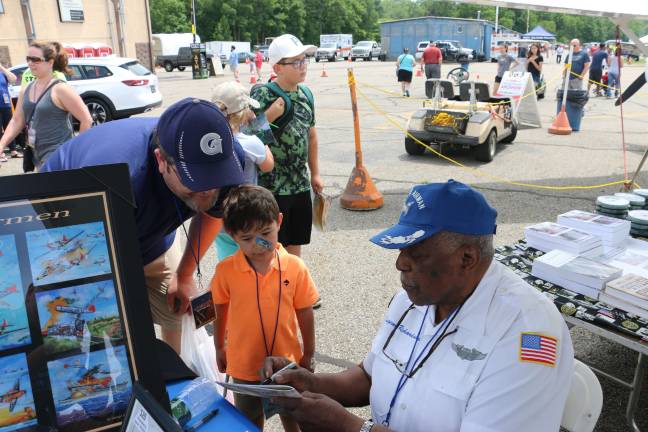 Photos by Don Webb Tuskegee Airman Eugene Richardson Jr. Richardson signs autographs at the Greenwood Lake Airport Air Show.