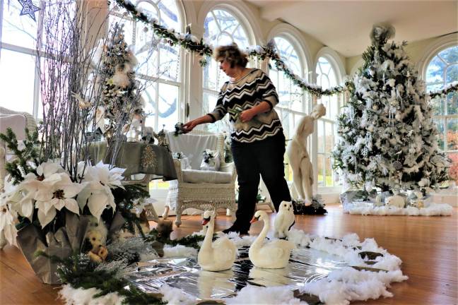 Don Webb photos Women's Club President Tina Ree puts out items for display at Ringwood Manor.