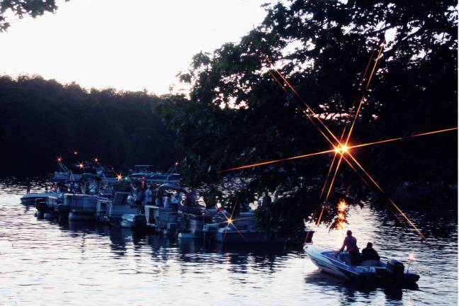 Boats gather at the dam end of Upper Greenwood Lake for the annual fireworks show. Many boats tie up together and enjoy the summer evening while they wait for dusk and the pyrotechnics to begin.