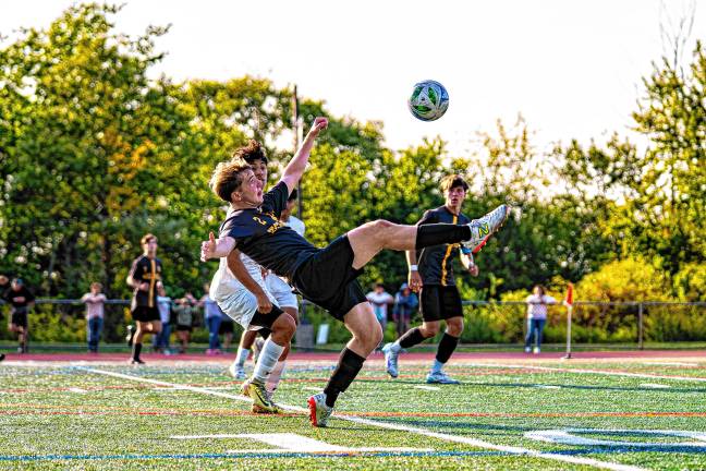 Junior Chris Orsino kicks the ball in midair.
