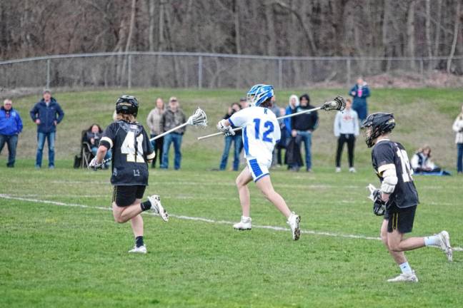 Kittatinny’s Shane Carman (12) carries the ball with his lacrosse stick. He is credited with scooping up three ground balls.