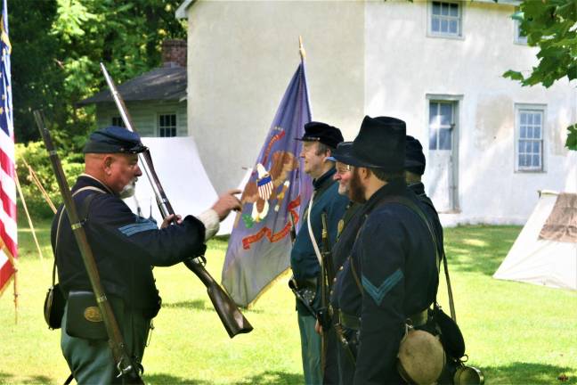 [Members of the 6th New Hampshire regiment Union Civil War reenactors hold a demonstration at the Long Pond Ironworks State Park in Hewitt on Saturday. Charles Kim photo]