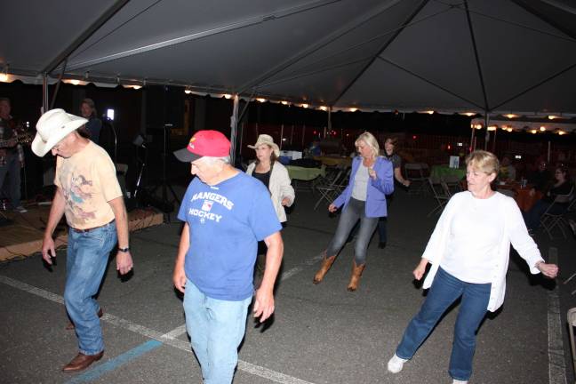 A cool late spring night was perfect for country line dancing to the music of Thunderhill. Photo by Ginny Raue