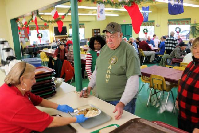 Photos by Don Webb Veterans line up for lunch at Camp Hope.